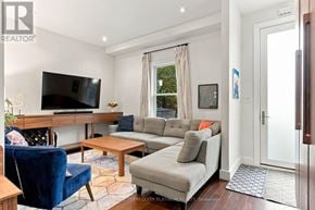 Toronto (South Riverdale) townhouse for rent - A living room with a blue chair and a grey couch.