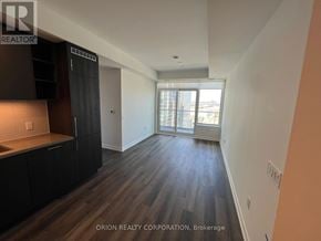Vaughan (Vaughan Corporate Centre) condo for rent - A spacious room with wooden floors and a large window.