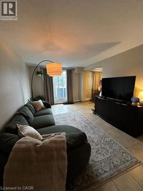 New Hamburg apartment for rent - A living room with a black couch and a television.