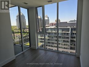 Toronto (Bayview Village) condo for rent - A room with a view of the cityscape through large windows.