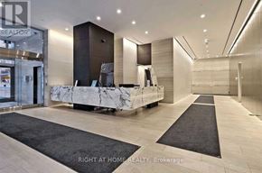 Toronto (Bay Street Corridor) condo for rent - A reception area with a marble counter and a black and white rug.
