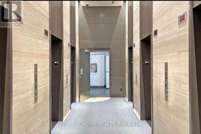 Toronto (Bay Street Corridor) condo for rent - A hallway with elevators and doors on both sides.
