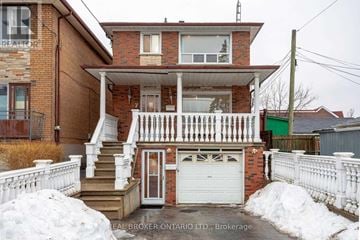 Toronto (Oakwood Village) apartment for rent - A house with a white fence and a garage door.