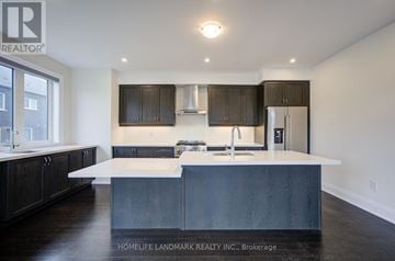 Richmond Hill townhouse for rent - A modern kitchen with dark wood cabinets and a white island.