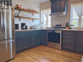 Barrie (Lakeshore) apartment for rent - A kitchen with a stainless steel refrigerator and wooden shelves.