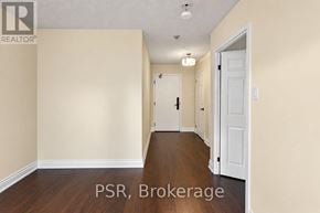 Oakville (Oo Old Oakville) condo for rent - A hallway with a door on the right and a wall on the left.