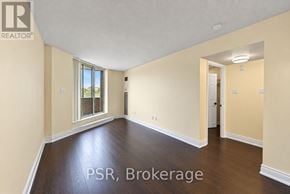 Oakville (Oo Old Oakville) condo for rent - A room with wooden floors and a window with a view of the outside.
