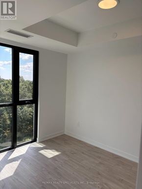 Milton (Cb Cobban) condo for rent - A room with a sliding glass door leading to a wooded area.