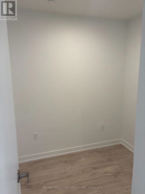 Milton (Cb Cobban) condo for rent - A room with a wooden floor and white walls.