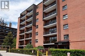 Mississauga (Port Credit) multi-family for rent - A tall red brick building with balconies and the number 1017 on the front.