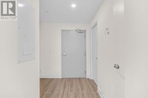 Welland (Broadway) condo for rent - A white door is in the middle of a hallway.