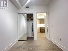 Toronto (Annex) condo for rent - A hallway with a white door leading to another room.