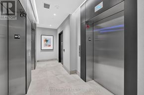 Milton (Tm Timberlea) condo for rent - A hallway with elevators and a painting on the wall.