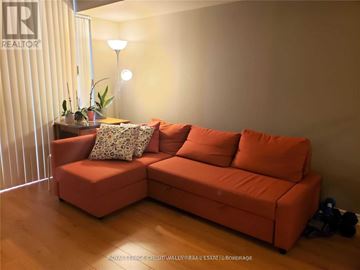 Mississauga (City Centre) condo for rent - A living room with a red couch and a lamp.