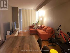 Mississauga (City Centre) condo for rent - A living room with a couch, television, and exercise equipment.