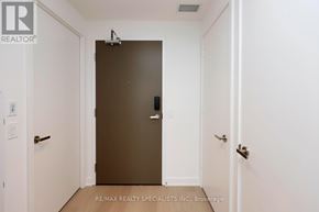 Mississauga (City Centre) condo for rent - A hallway with a brown door and white walls.