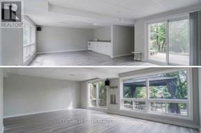 Oshawa (Mclaughlin) apartment for rent - A real estate listing image of a spacious room with a kitchenette and sliding glass doors leading to a patio.