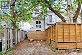 Toronto (South Riverdale) apartment for rent - A backyard with a wooden fence and a shed.