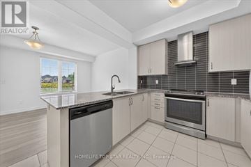 Newmarket (Glenway Estates) townhouse for rent - A modern kitchen with a stainless steel dishwasher and oven.