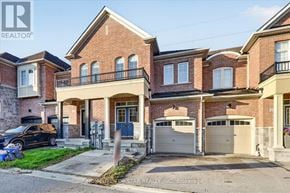 Newmarket (Glenway Estates) townhouse for rent - A house with a blue door and garage doors is for sale.
