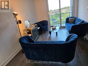 Mississauga (Lakeview) condo for rent - A blue chair is in the foreground of a room with a balcony.