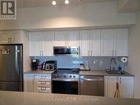 Mississauga (Lakeview) condo for rent - A kitchen with white cabinets and stainless steel appliances.