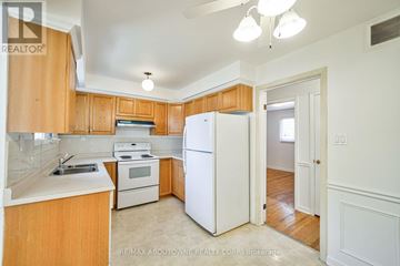 Burlington (Shoreacres) apartment for rent - A kitchen with wooden cabinets and white appliances.