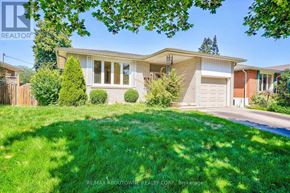 Burlington (Shoreacres) apartment for rent - A house with a well-maintained lawn in front of it.