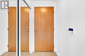 Toronto (Mimico) condo for rent - A pair of wooden doors with a modern locking system on the right side.
