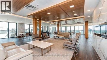 Toronto (Mimico) condo for rent - A spacious living room with a large white sofa set and a wooden ceiling.