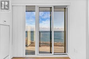 Toronto (Mimico) condo for rent - A sliding glass door with a view of the beach.