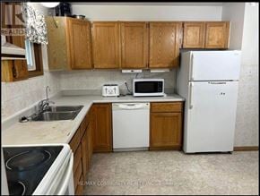 Kawartha Lakes (Lindsay) apartment for rent - A kitchen with wooden cabinets and white appliances.