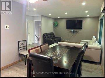 Kawartha Lakes (Lindsay) apartment for rent - A living room with a black table and a white couch.