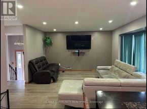 Kawartha Lakes (Lindsay) apartment for rent - A living room with a couch, chair, and television.