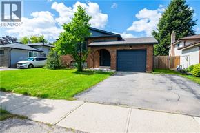 Kitchener apartment for rent - A house with a garage and a car parked in front.