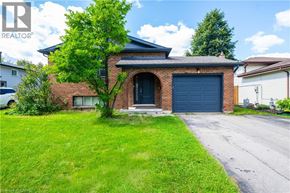 Kitchener apartment for rent - A house with a blue garage door is for sale.