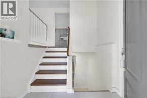 Kitchener apartment for rent - A staircase with a white railing and wooden steps.