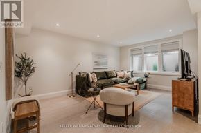 Toronto (The Beaches) apartment for rent - A living room with a couch, chair, and television.