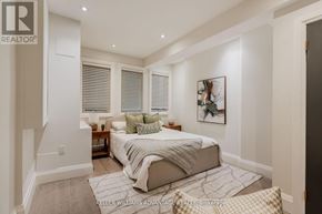 Toronto (The Beaches) apartment for rent - A bedroom with a bed, a nightstand, and a painting on the wall.