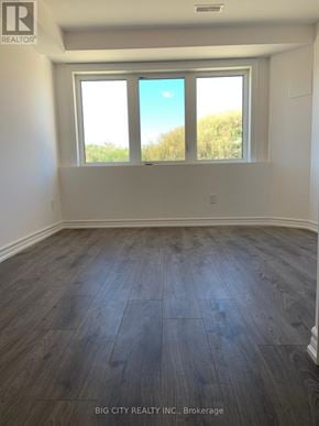 Richmond Hill (Oak Ridges) townhouse for rent - A room with a window and wooden flooring.