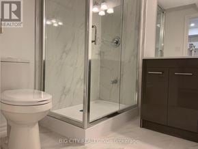 Richmond Hill (Oak Ridges) townhouse for rent - A white toilet sits next to a walk-in shower with a glass door.