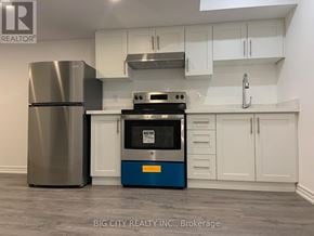 Richmond Hill (Oak Ridges) townhouse for rent - A modern kitchen with a stainless steel refrigerator and a blue oven.