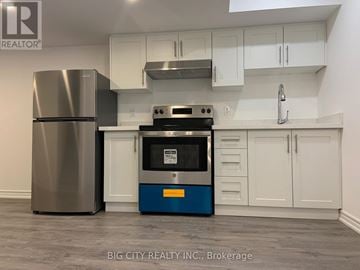 Richmond Hill (Oak Ridges) townhouse for rent - A modern kitchen with a stainless steel refrigerator and a blue oven.