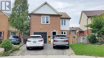 Mississauga (Creditview) apartment for rent - A two-story house with a garage and a car parked in front.