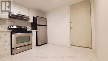 Mississauga (Creditview) apartment for rent - A kitchen with a stove top oven and a refrigerator.
