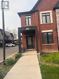 Burlington (Appleby) townhouse for rent - A brick building with the number 583 on the front.