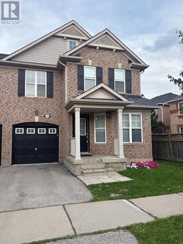 Milton (Be Beaty) apartment for rent - A house with a black garage door and a brick facade.
