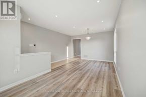 Milton (Be Beaty) apartment for rent - A spacious room with wooden flooring and white walls.