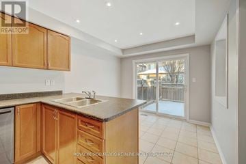 Milton (Be Beaty) apartment for rent - A kitchen with wooden cabinets and a granite countertop.