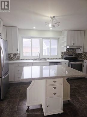 Burlington (Appleby) apartment for rent - A kitchen with white cabinets and a marble countertop.